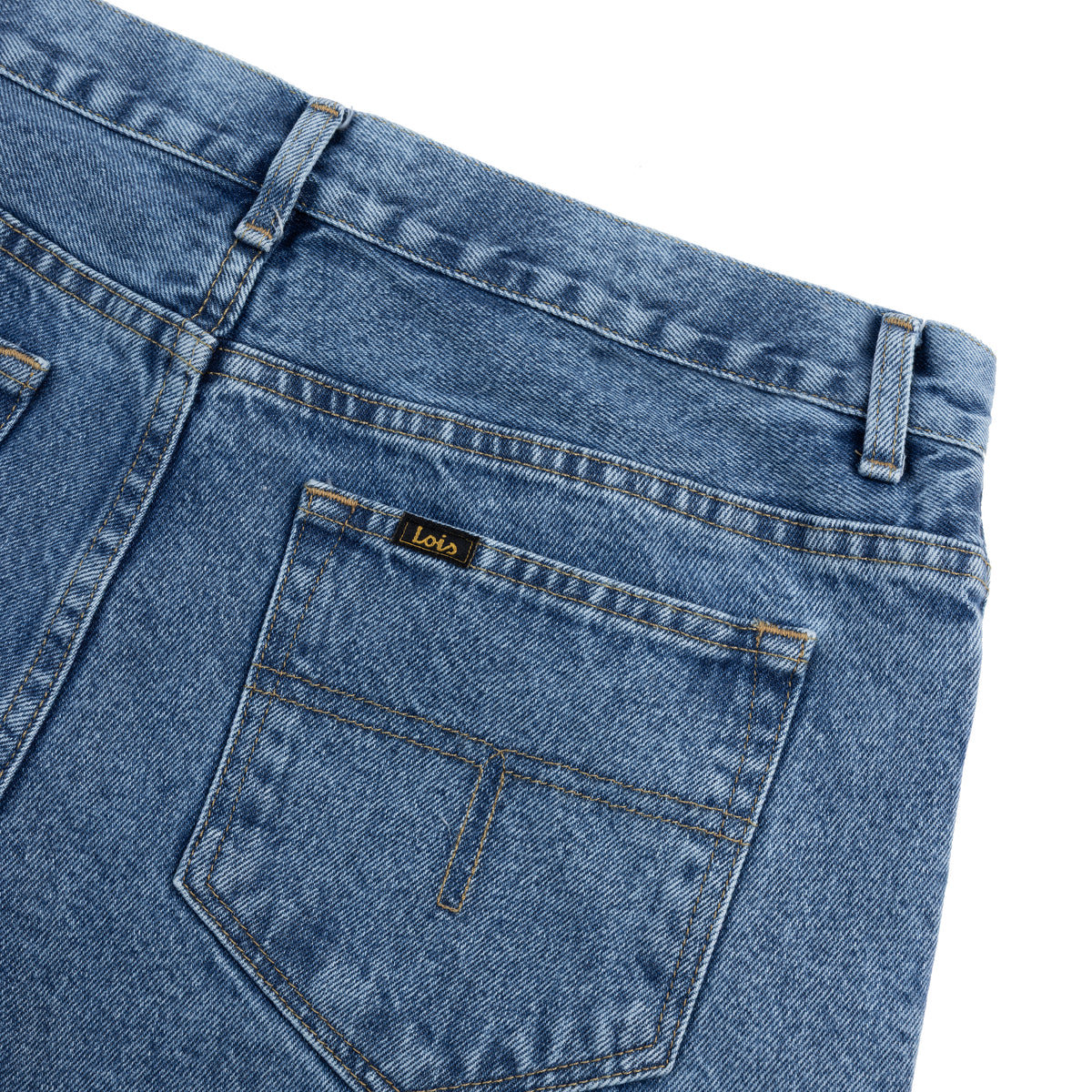 Close-up of blue denim jeans with a brand label on a white background