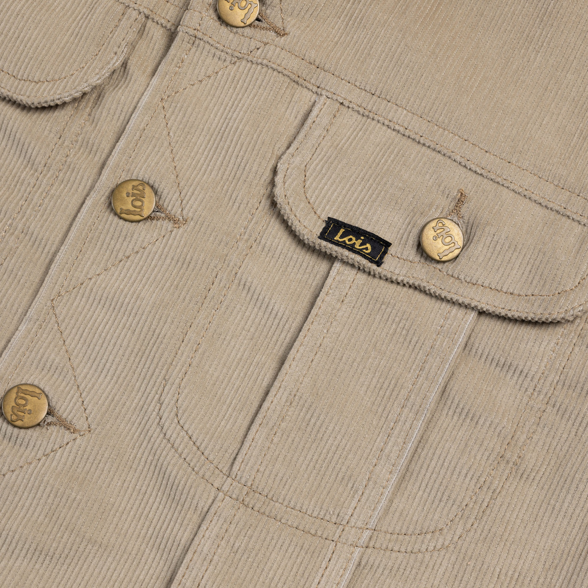 Close-up of beige corduroy fabric with buttons and a brand label.