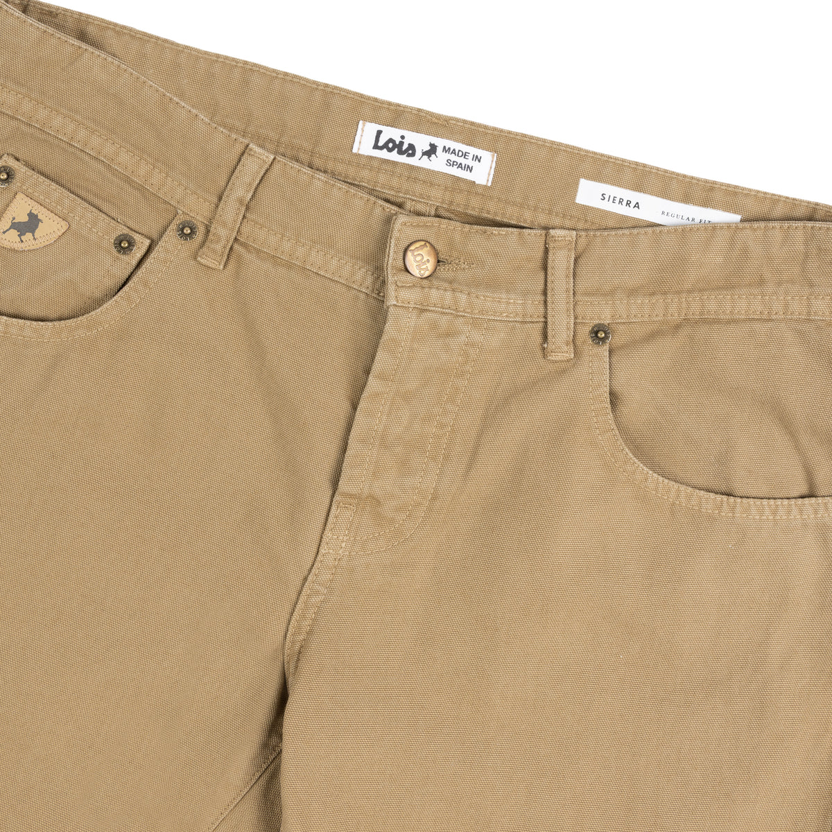 Close-up of fall leaf coloured canvas 5 pocket trousers showing the waistband, button closure, belt loops, front pocket, and inner labels reading 'Lois' and 'SIERRA'.