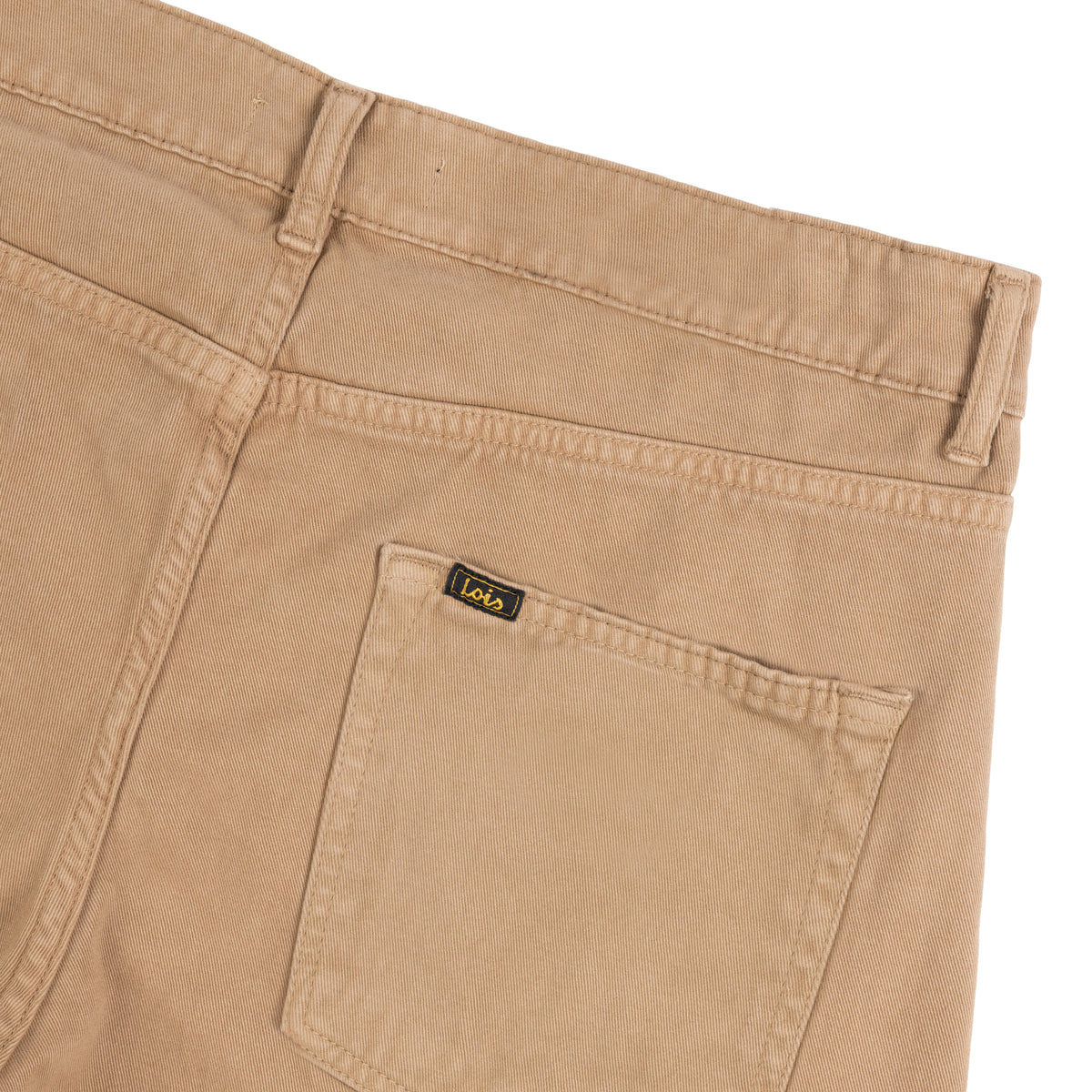 Close-up of tobacco brown moleskin jeans showing the back waistband, belt loops, and a back pocket with a small black branded Lois tab.