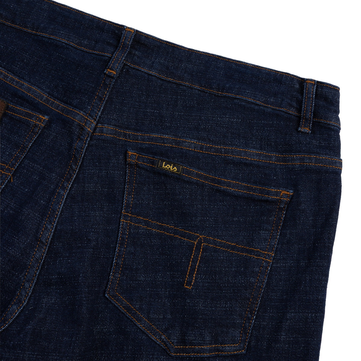 rear view close-up of dark blue jeans with a brand label on the back pocket against a white background