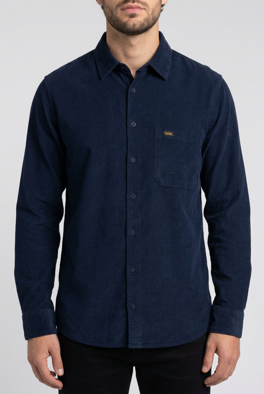 A dark navy blue long-sleeve button-up corduroy shirt with a classic collar and a single chest pocket, laid flat against a solid white background.