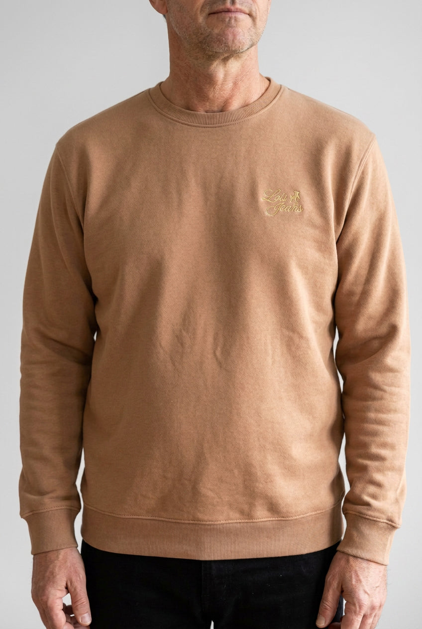 A mocca brown  crewneck sweatshirt with a small gold embroidered logo on the left chest, displayed flat against a white background.